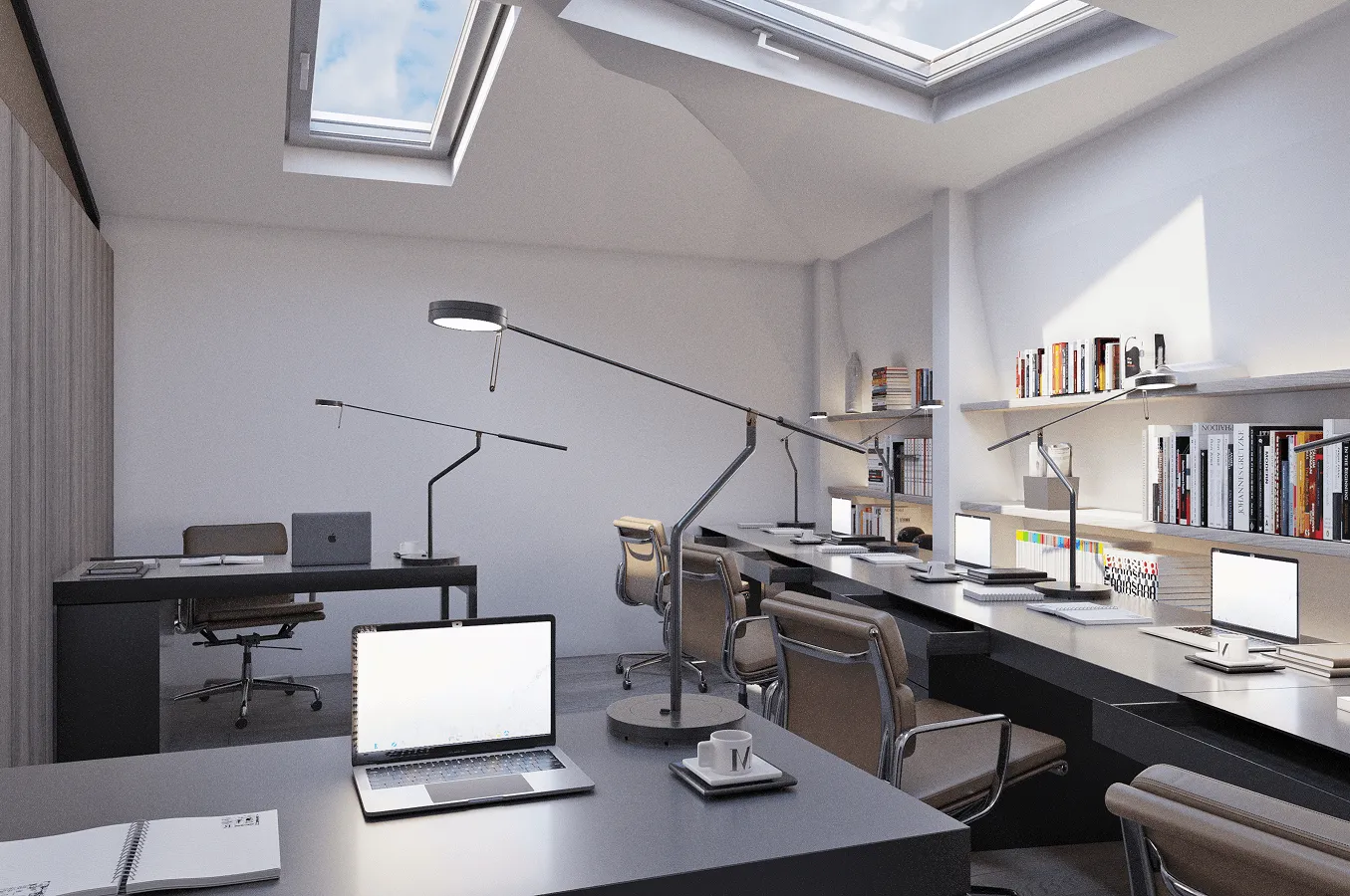 Modern office workspace with multiple desks, ergonomic chairs, laptops, task lamps, bookshelves, and skylights providing natural light.